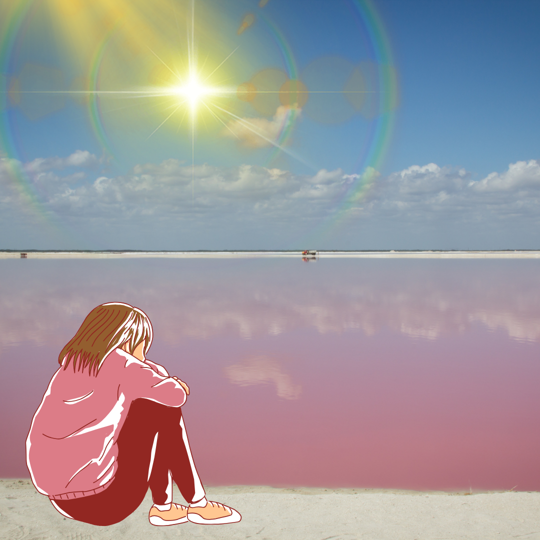 Mädchen sitzt bei strahlender Sonne traurig am Meer